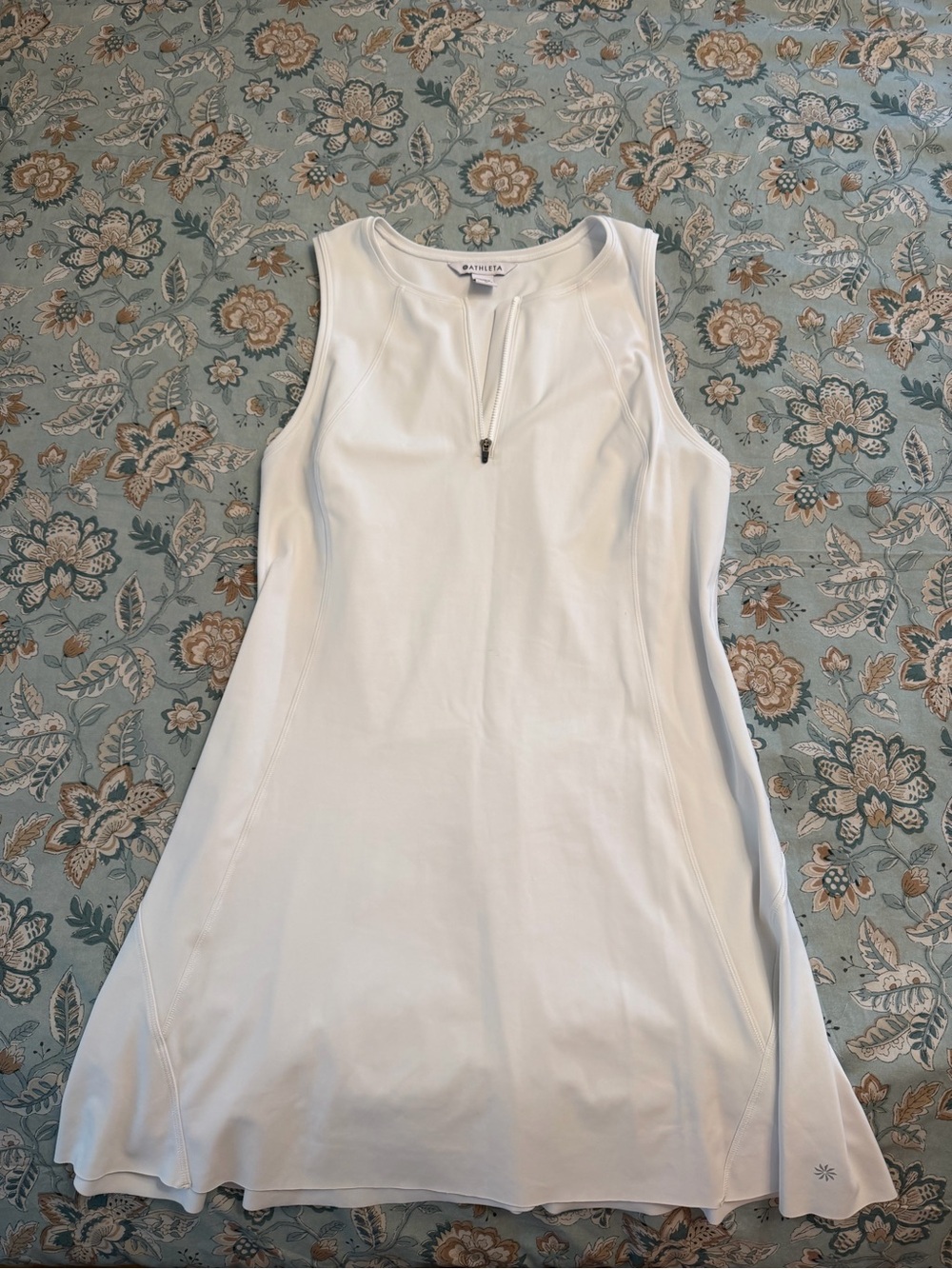 White sleeveless athletic top with front zipper